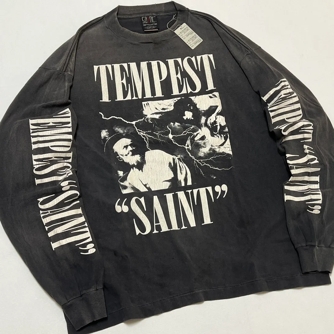 SAINT Mxxxxxx LS TEE/TEMPEST/BLK 'TEMPEST SAINT' Storm Religious Saints Cracked Retro Vulcanized Heavy Wash Long Sleeves Washed Black S-XL Assute Dyeing Multi-bit Horse Fading Craftsmanship Grinding and Hanging Holes Full of Old Feeling Top Printing Craftsmanship Purchasing Level